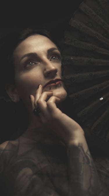 portrait of a woman holding a black fan