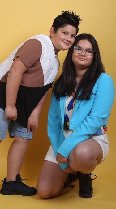 a boy and girl posing for a photo