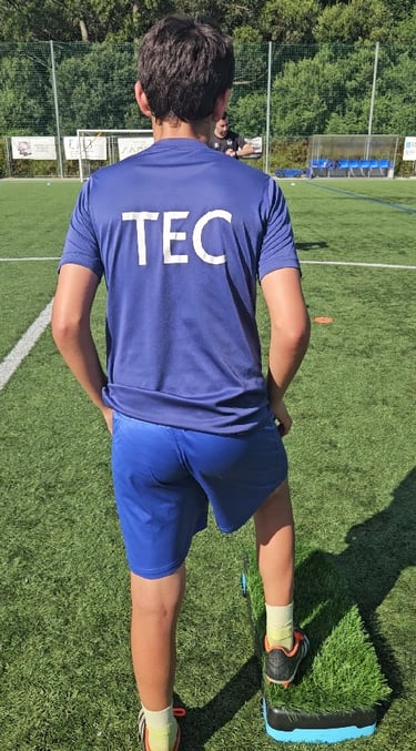 a man in a blue shirt and shorts playing soccer