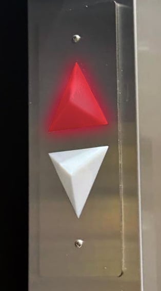 arrow indicators inside the elevator showing the elevator is going up by lighting the UP arrow red