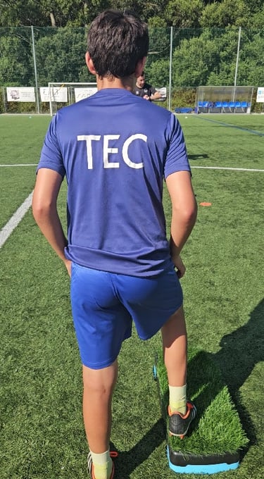a man in a blue shirt and shorts playing soccer