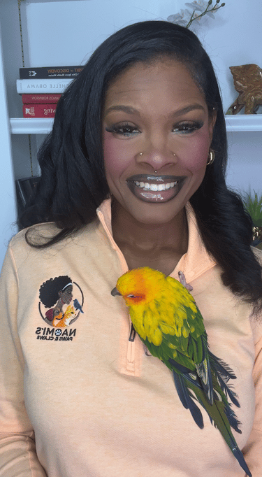 Naomi with Tobia, her Sun Conure. Tobia was 17-years old when she died peacefully. 