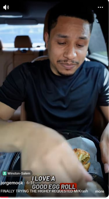 a man in a car with a sandwich on it