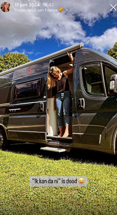 Smiling woman in a camper van — symbolizing taking life back into her own hands