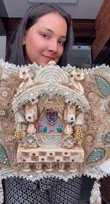 a woman holding a decorative piece of art