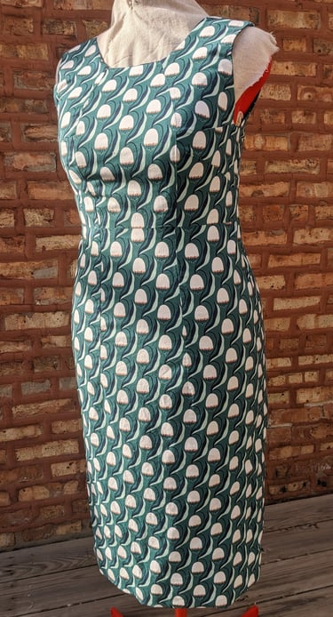 The front of a green art nouveau reversible sheath dress