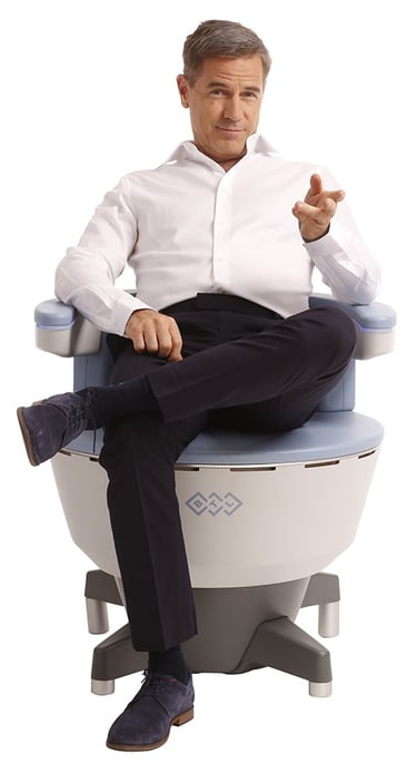 Man seated on an Emsella chair for non-invasive treatment of urinary incontinence