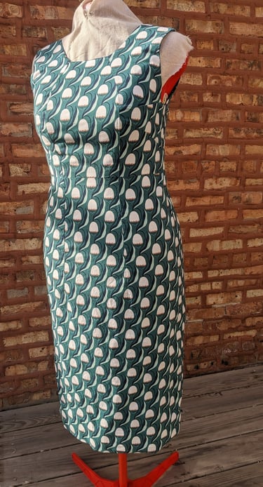 The front of a green art nouveau reversible sheath dress