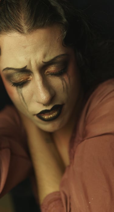 a woman with black makeup and makeup dropping on her face