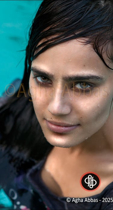 close-up of a beautiful , green eyed, dark hair, sexy young girl in a swimming.  pool, 