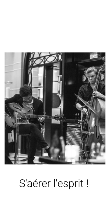 a man playing guitar in a cafe