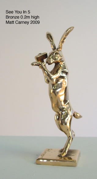 a statue of a rabbit looking at watch holding a phone