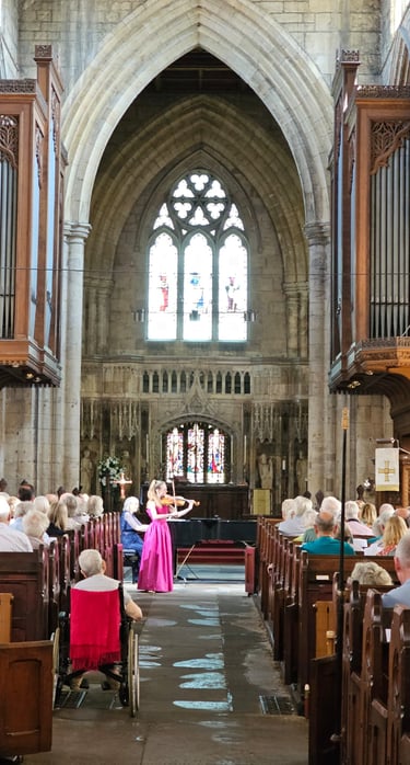 Charlotte Rowan performing in pink dress, live at Howden Minster, Yorkshire