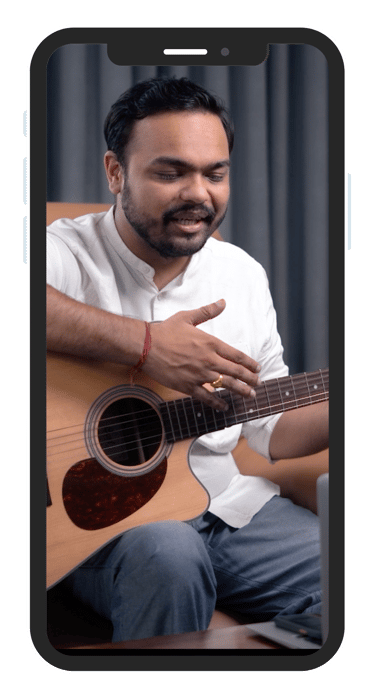 Music teacher teaching guitar on online class on mobile phone