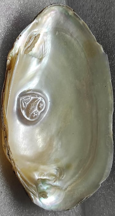 "11mm white cultured pearl with engraved heart motif–using nucleus technique-for overseas demand"