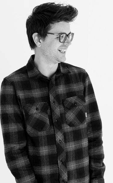 a man in a plaid shirt and glasses