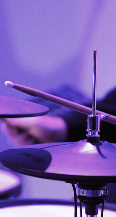 Purple lighting with up close drums