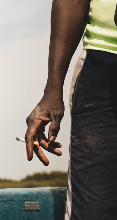 a man holding a cigarette in his hand