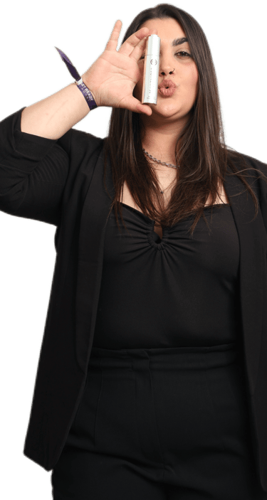 a woman with a rejuvenique oil in her hand