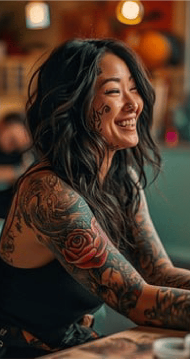 Image of a woman with tattoos smiling