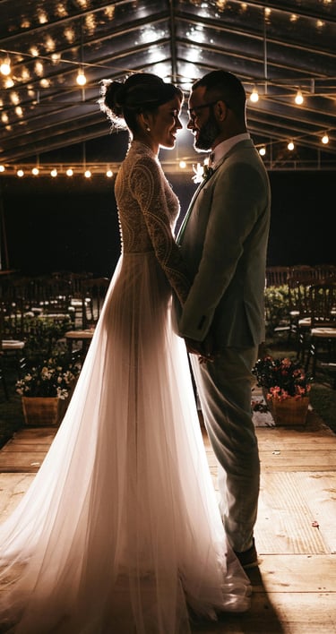a bride and groom standing in a tent