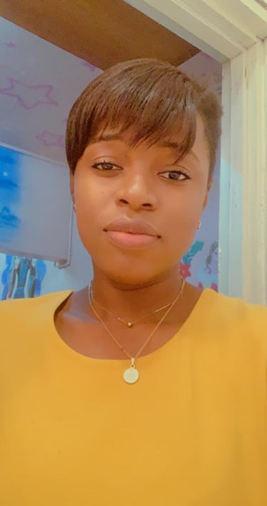 a woman with a yellow shirt and a necklace