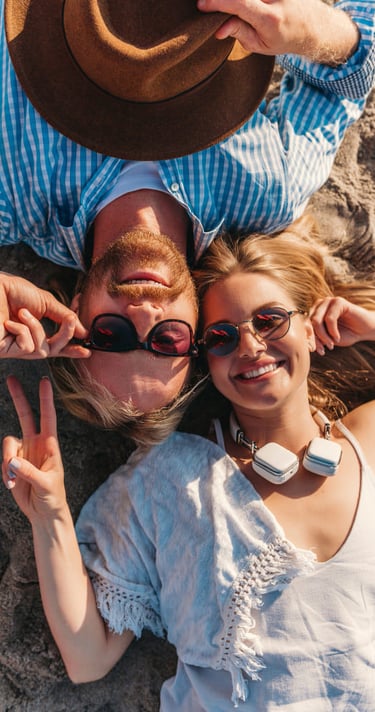 a sugar baby and a sugar mommy laying on the beach