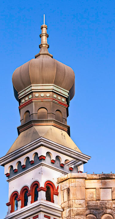 Historic Georgetown, Texas building featuring iconic onion dome architecture under a bright blue sky.