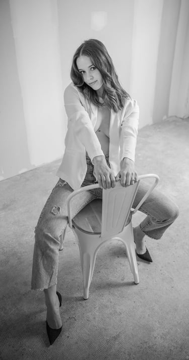 a woman sitting on a chair in a room during a shooting photo 