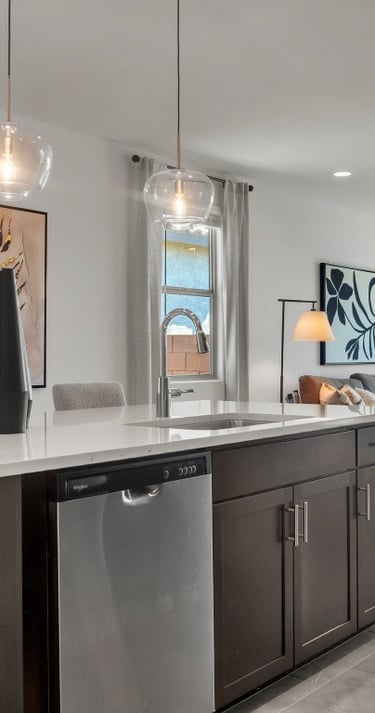a kitchen with a large window and a table with chairs
