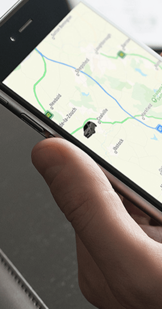 SmarTrack vehicle tracking app on smartphone showing live location map.