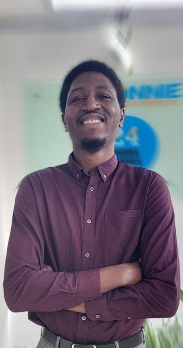 a man in a purple shirt and gray pants