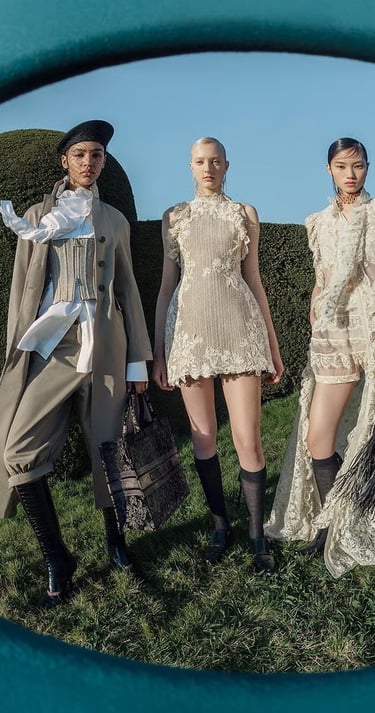Three models in Dior couture posing outdoors in structured and lace ensembles.