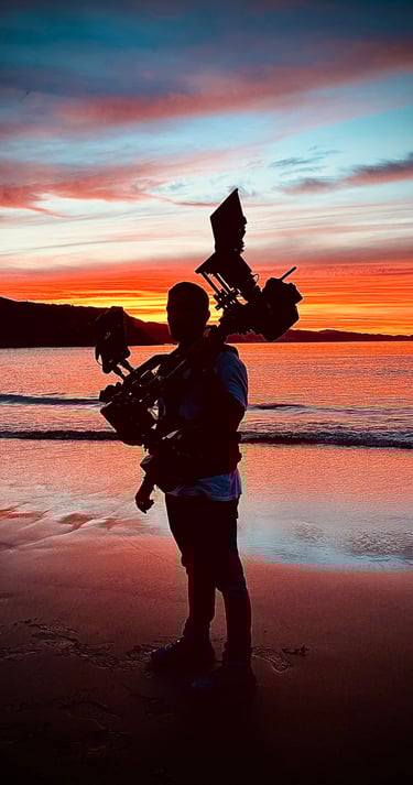 Steadicam operator silhouette at sunshine on the beach