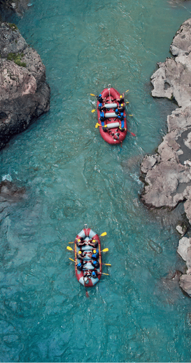a group of people rafting down a river