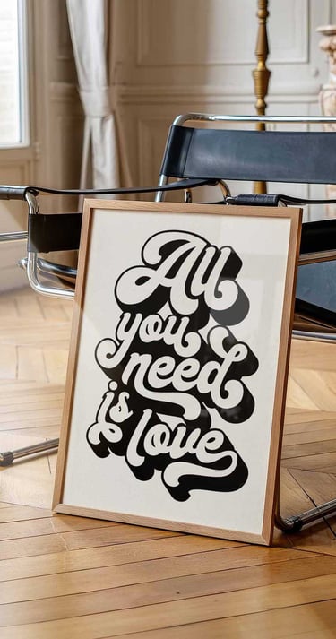 Retro black and white typography wall art featuring the quote All You Need Is Love