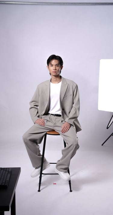 Derron posing in formal outfit during indoor photoshoot