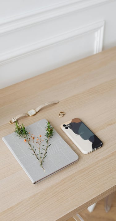 a phone phone with a plant in a vase on a table