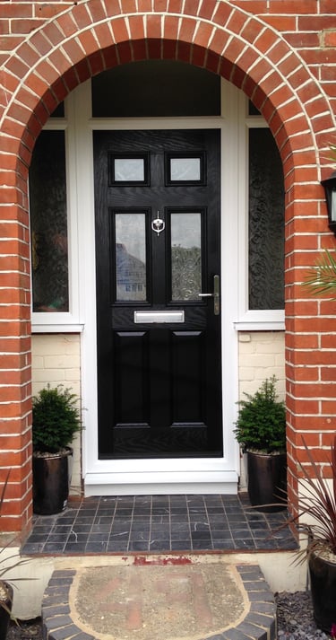 a black front door 2 panel 2 square glass with side panels