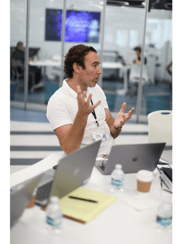 a man in a white shirt and a laptop computer AI training