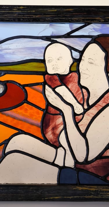 a painting of a woman holding a baby in a stained glass window