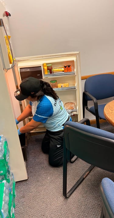Commercial cleaning staff sanitizing office workspace