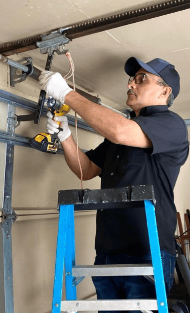 a man in a blue shirt is holding a tool and a tool