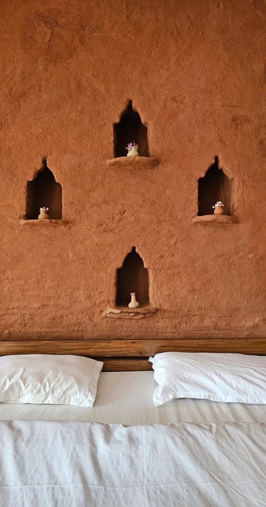 Rustic mudstone wall room with sit-out deck in Ilika Resorts