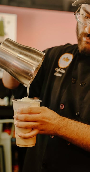 cafe con chisme barista making a latte