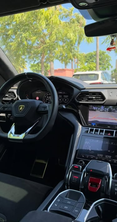 Interior luxury cockpit of a Lamborghini Urus SUV featuring a digital dashboard and infotainment system.