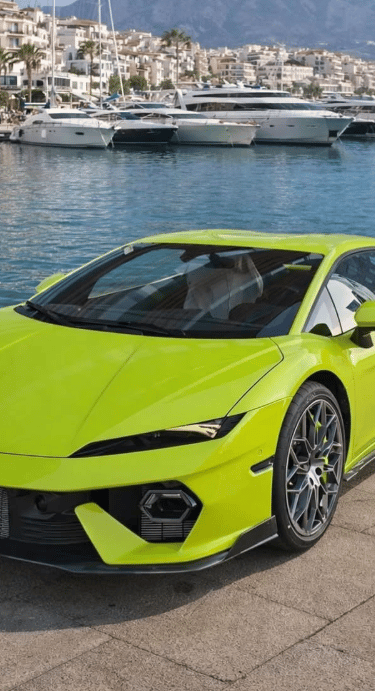 A lime green Lamborghini supercar parked at a luxury yacht marina in Puerto Banus, Spain.