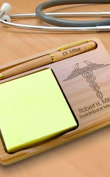 Personalized wooden desk organizer with engraved medical caduceus, name, and pen holder for doctors.