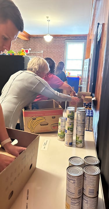 a man is standing in a box of cans of soda