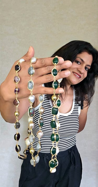 Woman showcasing vibrant global-inspired gemstone necklaces from Iridezza’s Global Glam jewelry coll